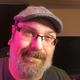 Mike Fahey of Kotaku looks toward the camera while sitting in a gaming chair.